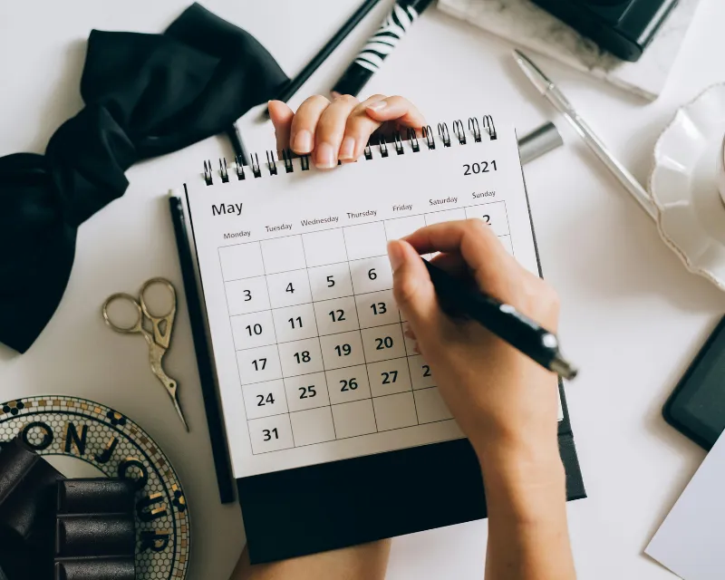 woman reviewing a calendar to work out her cycle and when PMDD is likely to occur