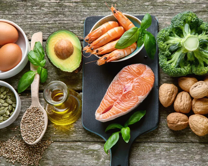 plate of healthy foods like fish and eggs and vegetables and nuts showing foods you can eat which would be rich in supplements and vitamins which could help with pmdd