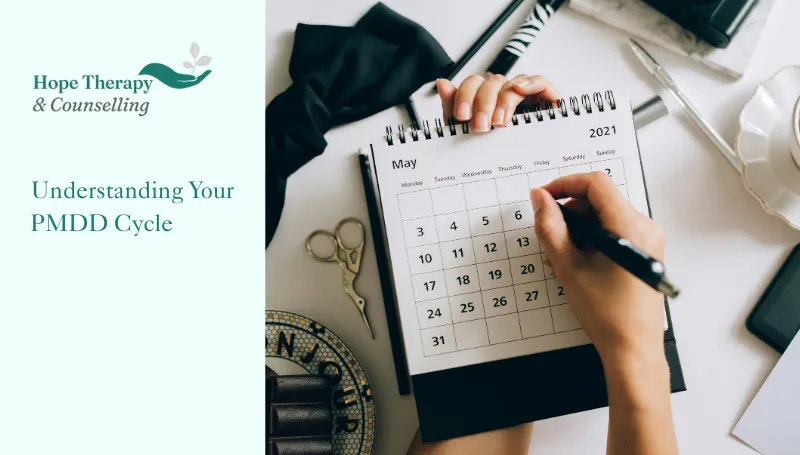 hope therapy and counselling branding and title text next to an image of a woman trying to understand her PMDD cycle using a calendar